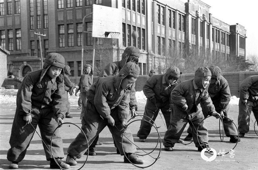 1957年冬，沈阳市一个小学的学生在滚铁环。